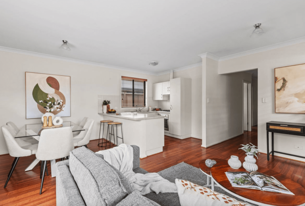 Open-plan living, dining and kitchen area in a modern 3-bedroom home in Athol Park, SA, with timber floors, white cabinetry and a bright, low-maintenance layout.