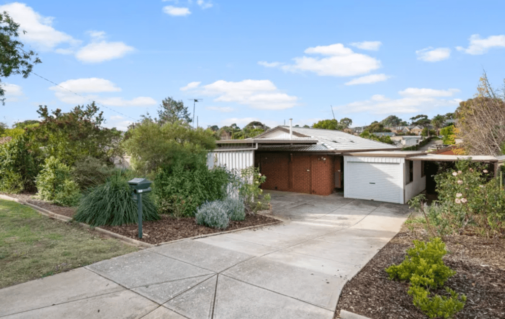 Single-storey brick home in Morphett Vale, SA on a 722m² block, featuring established gardens, dual driveways/carports and strong renovation potential.