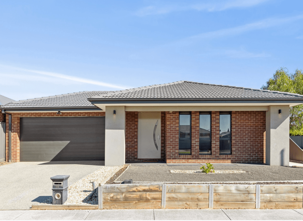 Modern brick home in Lara, VIC with a wide frontage, double garage, tiled roof, minimalist landscaping and a contemporary entryway.