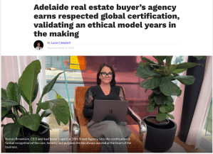Kerryn Brownson, CEO of 28th Street Agency, seated with a laptop following global certification recognition for ethical business practices.