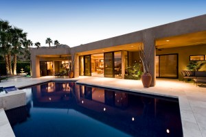 Luxury modern home with resort-style pool, outdoor entertaining area and contemporary architectural design.